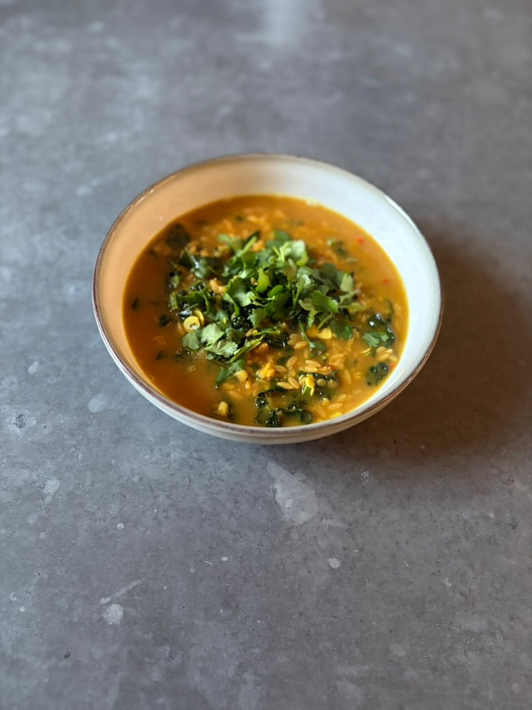 Coconut-Ginger soup with red lentils and greens